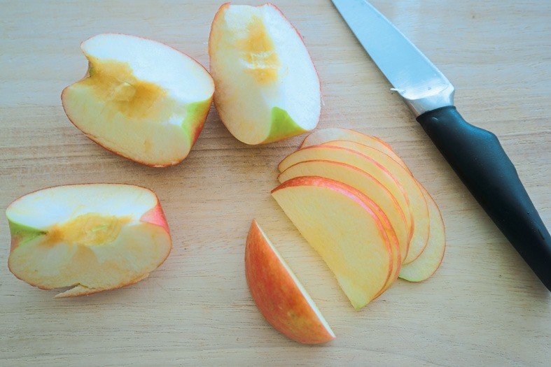 Помытые яблоки разрежь на 4 части, удали сердцевину. Тонко нарежь. Чтобы ломтики стали эластичными, поставь их на 1 минуту в микроволновку.